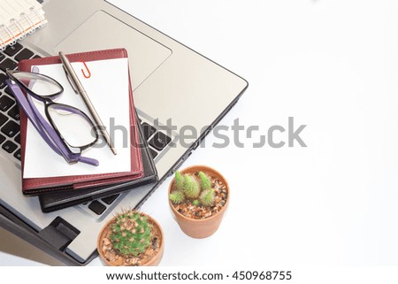 office stuff with laptop and notepad top on white table. business concept