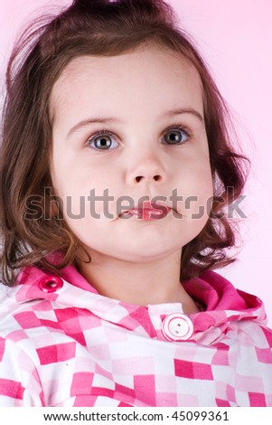 Cute little girl on a pink background