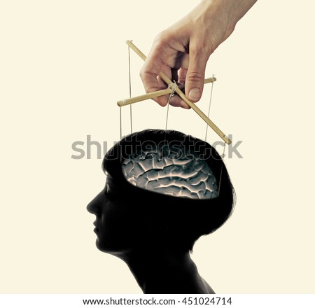 image of a hand, that manipulates the mind of another person, isolated and toned  Royalty-Free Stock Photo #451024714