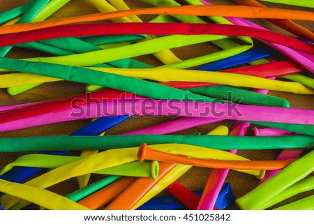 Deflated color rubber air balloons on wooden background