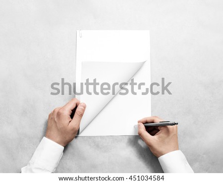 Hand holding blank agreement mockup and signing it. Arm in shirt hold clear document template mock up. Contract surface design. Simple pure legal paper print display. Reading contract statement.