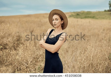 Pretty young woman in the meadow