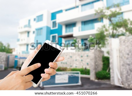 woman use mobile phone and blurred image of blue hotel for background