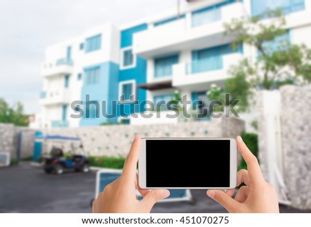 woman use mobile phone and blurred image of blue hotel for background