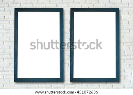 empty frame on the wall of white brick.
