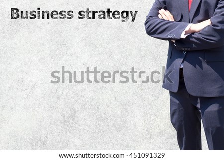 Man in suit on a concrete wall background. Business man success or soft Business man success in he working on marketing online or e learning with global learning on over blurred old cement wall. 