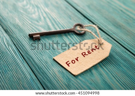 real estate rent concept - old key with tag Royalty-Free Stock Photo #451094998