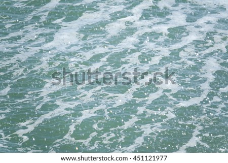 green sea water texture with water spray,select focus with shallow depth of field:ideal use for background.