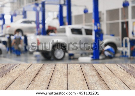 Wood table top with blur garage background, for product display
