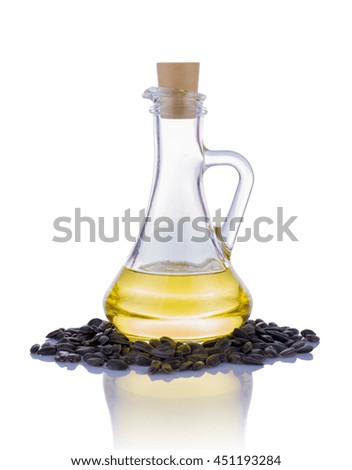 Sunflower seeds and oil in bottle isolated on white background.