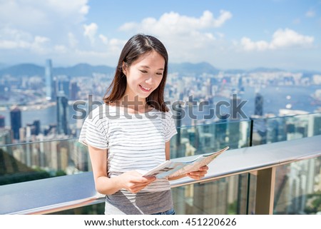 Woman looking at the city map in Hong Kong