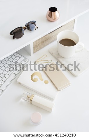Desktop workplace top view. Modern trend template for advertising, product mock up. Presentation template. Coffee, keyboard, sunglasses, book, phone, perfume. White and gold. Minimalistic desk set.