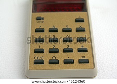 old calculator.
white calculator.