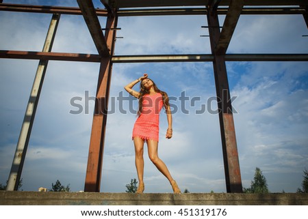 Portrait of a beautiful young girl at a construction site premises