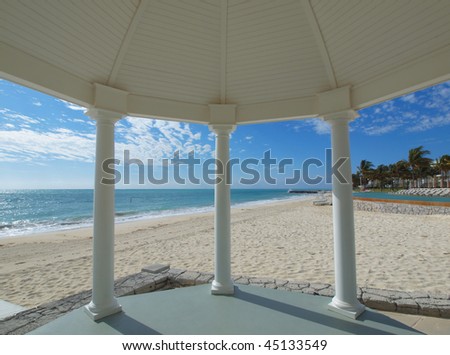 White gazebo for weddings overlooking tropical beach