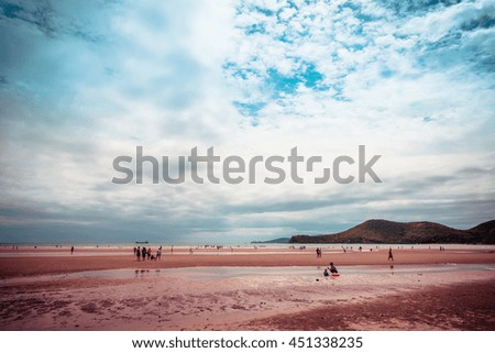 Sea sand sky and vintage summer day. Foot print on a summer sandy ocean beach. Lounge chair in the tropical beach. Close up sand with blurred sea sky vintage tone, summer day, copy space for product. 