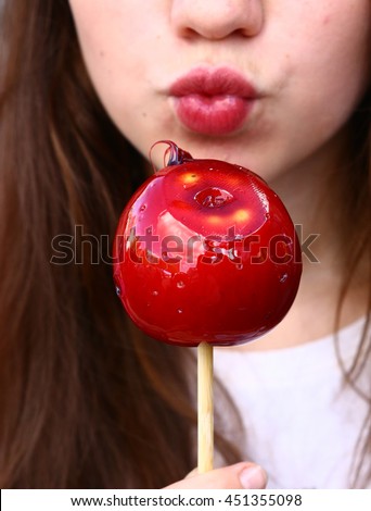 pretty teenage girl with candy red apple close up photo 