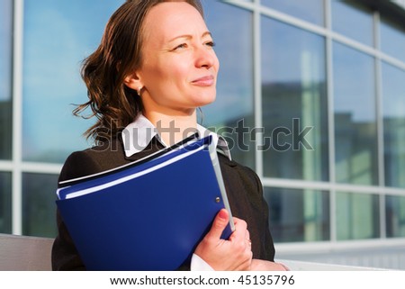 Confident businesswoman with a folder.