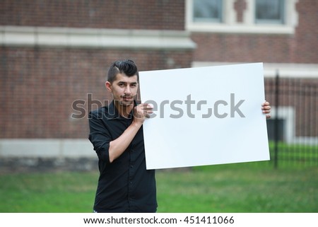 advertising man with a white board on hands, male looking to another camera