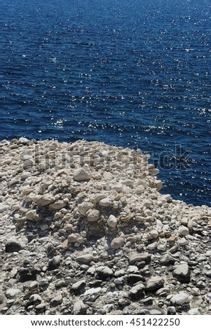 White stones on blue sea background in summer, sunner in  Greece, white stones on blue background, Diaplo, Ionian, Greece