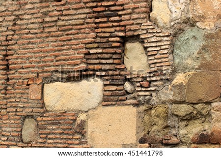 Old red brick masonry and yellow stone slabs background. Cracked walls of ancient church in Tbilisi, Georgia
