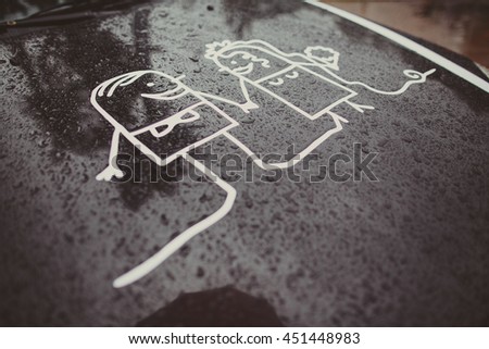 Animated picture of newlyweds on the black car