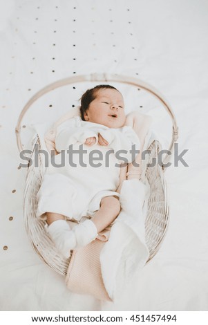 little lovely girl lying in the basket