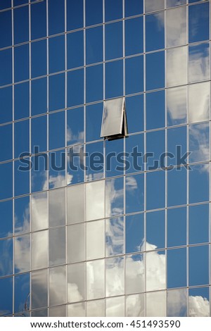 Reflection of the sky in the mirrored windows of a skyscraper, background, texture