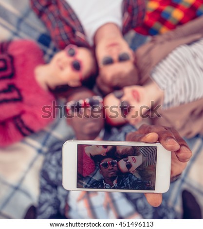 Toned. Picture of best friends making selfie on mobile or smart phone while spending free time on picnic in parkland.