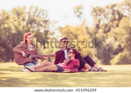 Toned. Picture of best friends making selfie on mobile or smart phone while spending free time on picnic in parkland.