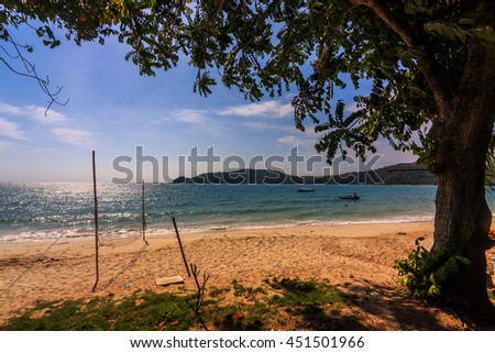 Tropical beach with exotic trees on the sand/Luxury destination. Manana Beach, Borneo  Image has grain or blurry or noise and soft focus when view at full resolution. (Shallow DOF, slight motion blur)