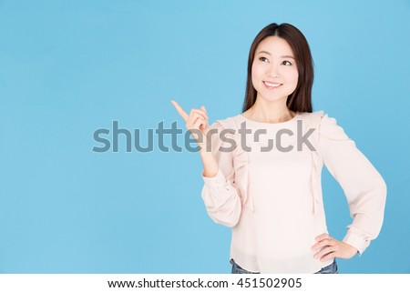 portrait of attractive asian woman isolated on blue background