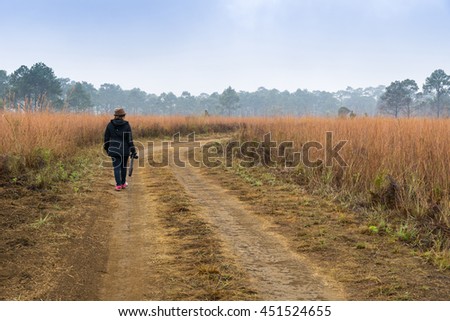 Road of savanna Field with woman photographer