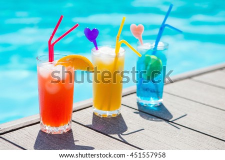 Colored cocktails on a background of water