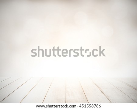 The blur nature greenery bokeh leaf wallpaper with white wood floor foreground on spring autumn park background. soft focus light view leaves flare;rays abstract tree foliage forest landscape gradient