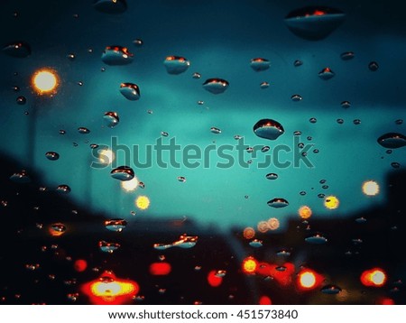 Raindrops on the windshield, while traffic jams.
