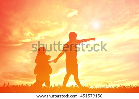 Silhouette children on sunset