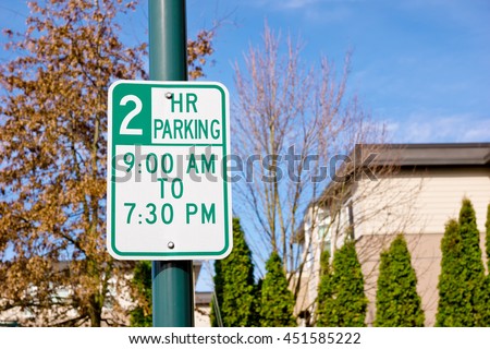 Parking sign posted for two hours only off a city street.