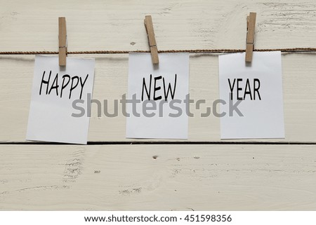 Note pad pinned on string with text. HAPPY, NEW, YEAR