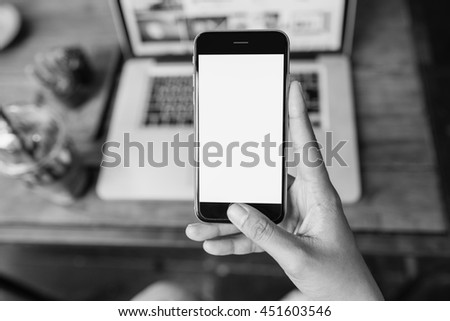 Hand holding smartphone white screen girl using smartphone in cafe. 