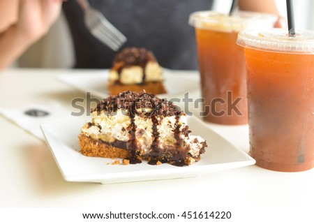 Woman's about to eat banoffee pie with drinks on a date photo