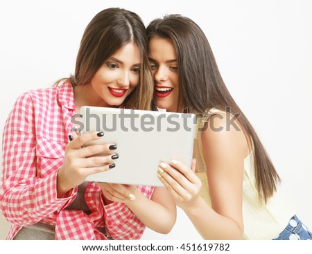 two girls friends taking selfie with digital tablet over white background