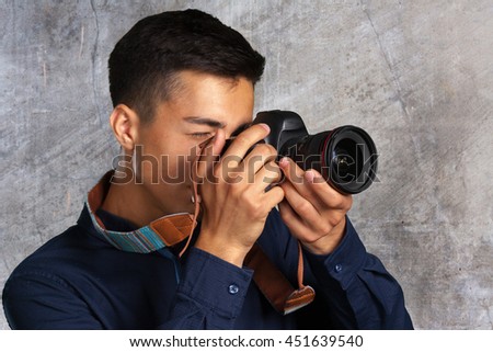 Happy man taking pictures with digital camera