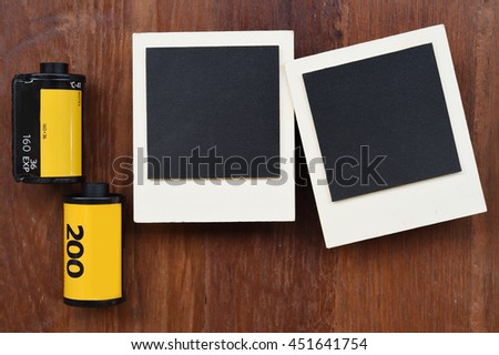 Photo film with photo frames on wooden background