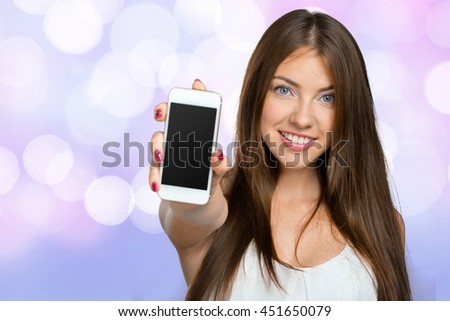 Smiling woman showing smartphone screen