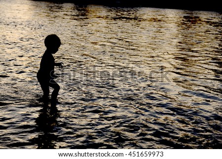 silhouette children in water