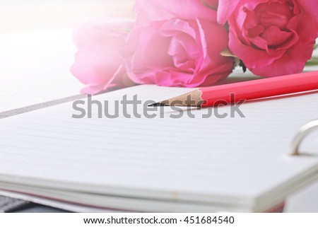 Pencil with pink roses And book more closely.