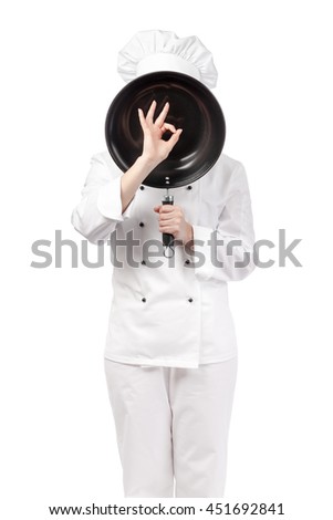 female chef, cook or baker with hidden face behind frying pan showing an okay sign isolated on white background. advertisement gesture. food, restaurant and cooking concept
