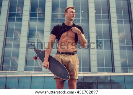 Attractive male with longboard showing his muscular stomach.