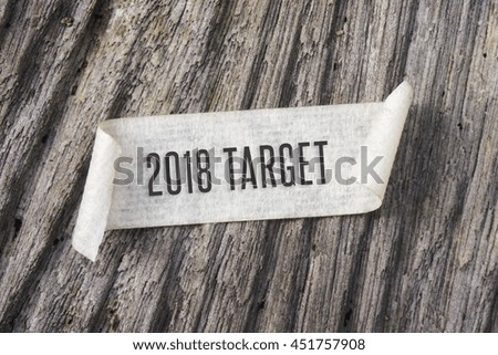 TORN paper with 2018 TARGET word on wooden background. GRAIN AND RUSTIC EFFECT.